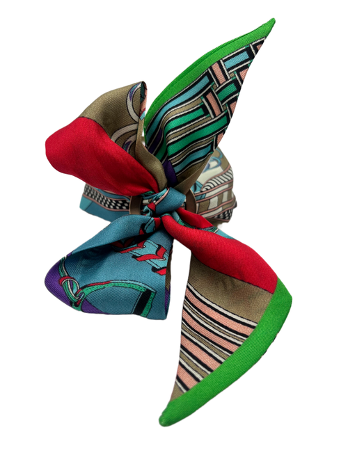 Colorful patterned fabric bow on a white background